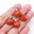 Faceted red jasper teardrop pendants for DIY necklaces held in hand for scale - 16x17mm / Rainbow Stone