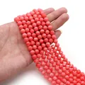 Detailed view of polished pink marble texture synthetic gemstone beads for DIY jewelry - 4mm / Coral Red (Marble Texture)