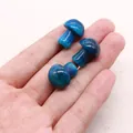 Macro shot of three blue dragon vein agate mushroom beads held in hand for scale - Polished Mushroom Loose Bead / Blue (No.3)