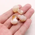 Close-up of three polished mini mushroom stones in cream with natural brown veining - Agate