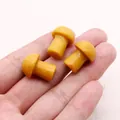 Macro shot of three polished mushroom-shaped dragon blood stone beads for DIY jewelry - Yellow (No.4)