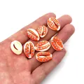 Detail of orange cowrie shell charms with blue dots for DIY jewelry making - Style 4 (Orange with Blue Dots)