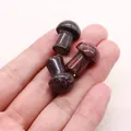 Dragon blood stone mushroom carvings held in hand for size comparison - Dragon Blood Stone (Flower Red Stone)