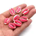 Pink and white candy-colored sea shell beads held in hand for jewelry DIY projects - Bright Pink And White