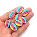 Detail of colorful gradient cowrie shell beads in pink, blue, and yellow for DIY jewelry - Size 7