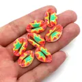 Close-up of hand-painted natural cowrie shell beads with colorful floral bohemian patterns - 9x19mm (20 Pieces/Pack) / No. 3 (Red Star Pattern)