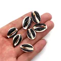 Macro detail of black and white natural cowrie shell beads for DIY jewelry making - Black and White Patchwork