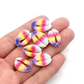 Macro view of gradient rainbow seashell beads held in hand for DIY jewelry making - No. 1