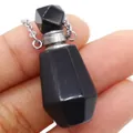 Natural black gemstone perfume bottle pendant with silver chain held in hand - 25x38mm / Black Agate