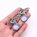 Macro view of vintage silver dragon pendant with iridescent opal gemstone detailing - 43x43mm / Opal