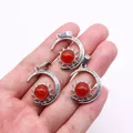 Detailed view of crescent moon and sun pendants with red stones held in hand - Pendant Only (22x29mm, Without Chain) / Red Agate