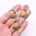 Detailed view of three silver crescent moon and sun pendants with amber gemstones - Pendant Only (22x29mm, Without Chain) / Topaz
