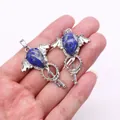 Silver winged key pendant featuring a blue natural stone teardrop on a hand-held display - Lapis Lazuli