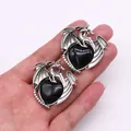Gothic dragon heart earrings in vintage silver with black gemstone on white background - Black Agate