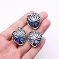 Silver tree of life heart pendant with natural blue lapis stone held in hand - Lapis Lazuli