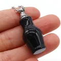 Miniature black natural stone perfume bottle pendant with silver chain held in hand - Vase Shape (Carved Bottle) / Black Agate