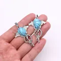 Silver angel wing pendant set with turquoise drop stone and intricate metal frame - Blue Turquoise