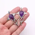 Gothic amethyst teardrop pendant with silver wing sceptre detail held in hand - Purple Crystal