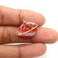 Detailed view of hand-wrapped wire striped agate pendant held to show scale and texture - Red and White Striped