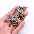 Vintage silver dragon pendant featuring tiger eye gemstone held by hand for size reference - 43x43mm / Tiger's Eye