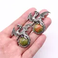 Silver viking dragon pendant with green natural stone sphere held by hand - 43x43mm / Unakite