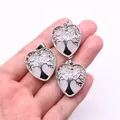 Silver tree of life heart pendant with pink crystal quartz held in hand for scale - White Jade