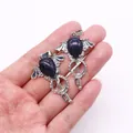 Blue sandstone angel wing pendants with silver key design held in hand for jewelry making - Blue Sandstone