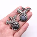 Vintage silver Viking dragon pendant clutching a dark iridescent gemstone on palm - 43x43mm / Larvikite