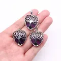 Three silver heart tree of life pendants with purple crystals held in hand - Purple Crystal