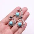 Set of silver sun and moon pendants with sky blue turquoise stones held in hand - Pendant Only (22x29mm, Without Chain) / Blue Turquoise