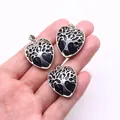 Three silver heart pendants with blue sandstone and tree of life design held in hand - Blue Sandstone