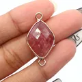 Macro shot of faceted pink strawberry quartz diamond connector with gold edges for DIY jewelry - Strawberry Quartz