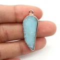 Detailed view of light blue feather stone pendant with golden metal edging and top loop - Sky Blue Stone (2)