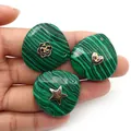 Close-up of teardrop malachite pendants with gold metal heart and star inlay details - Malachite (Heart)