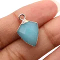 Macro shot of a faceted shield-shaped natural blue stone pendant with gold plating - Amazonite Texture
