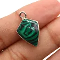 Macro detail of natural stone shield pendant with silver plating and green textures - Malachite