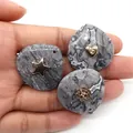 Hand holding three grey marble teardrop pendants with gold star heart and rose inlays - Map Stone (Heart)