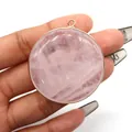 Detail of round rose quartz stone pendant with polished rose gold plated metal edge - Rose Quartz