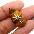 Tiger eye stone teardrop pendant with gold star inlay held between fingers - Pendant Only (Without Chain) / Tiger's Eye