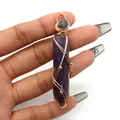 Macro detail of handmade gold wire-wrapped purple hexagonal crystal pendant in hand - Hexagonal Column Wire Wrap Style / Purple Crystal