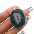 Detail of natural green agate slice pendant with gold plated edge held in hand - Dark Green Agate (No. 4) / Pendant Only (Without Chain)