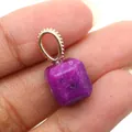 Macro shot of faceted purple gemstone pendant with detailed milgrain gold bail detail - Purple Jade