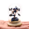 Hand holding a mini lapis lazuli crystal money tree in glass dome on wood base - Lapis Lazuli