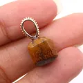 Macro shot of a square cut Tiger Eye stone pendant with golden granulated metal bail - Tiger's Eye