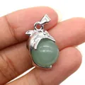Silver dolphin pendant with a green gemstone bead shown on a finger for size reference - Dolphin Shape / Green Aventurine