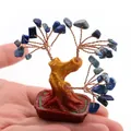 Lapis Lazuli crystal tree with hand-woven copper wire in a red ceramic pot on palm - Lapis Lazuli