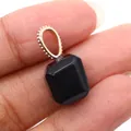 Faceted black onyx stone pendant with rose gold bail held by hand to show size - Black Agate