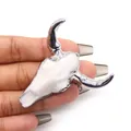 Detail of a white bull skull pendant with silver horns held in hand for scale - White Silver Horns (No. 1)
