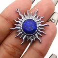 Close-up of vintage sun pendant with blue lapis lazuli stone and silver wavy metal rays - Lapis Lazuli