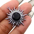Detail of sunflower pendant with silver curls and a large faceted black gemstone - Black Agate